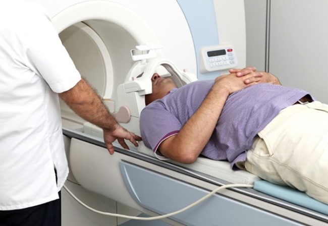 Положение пациента на столе томографа для КТ сканирования сосудов головы и шеи